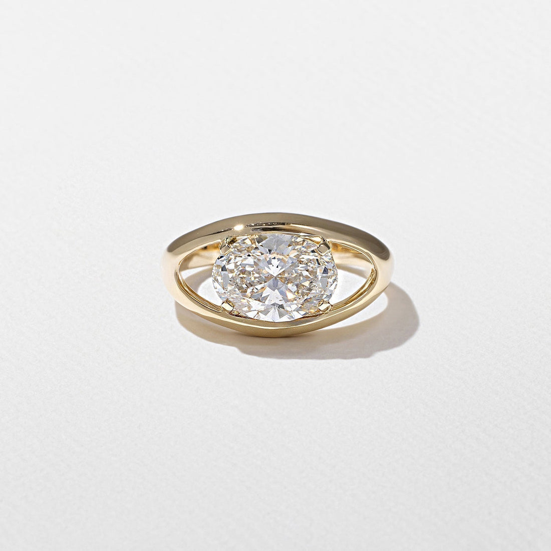 East west oval cut moissanite floating split shank engagement ring in yellow gold