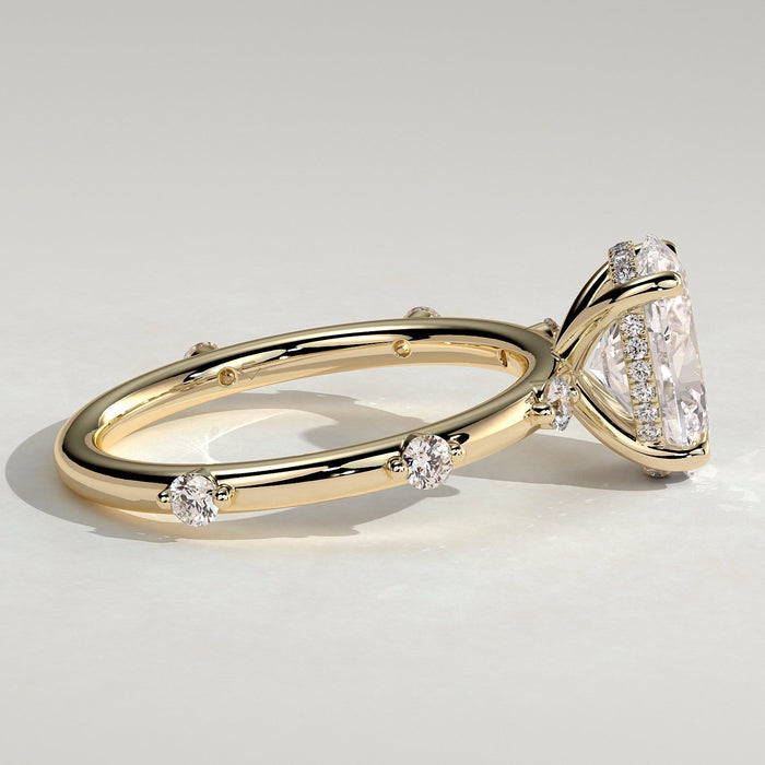 Oval cut moissanite engagement ring with graduated spaced accents in yellow gold, view 2