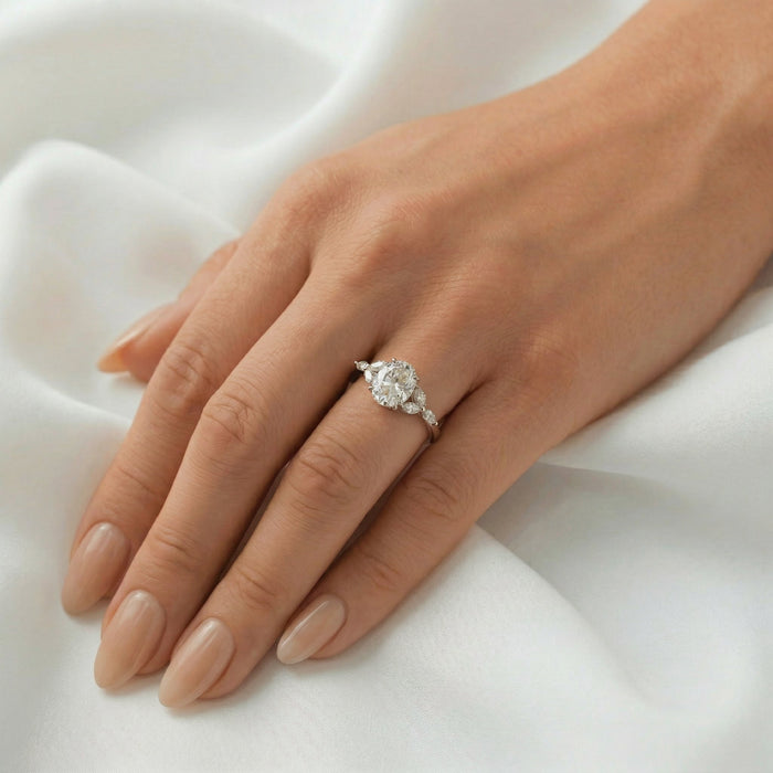 Oval cut moissanite engagement ring with graduated marquise shoulders on a flat white gold band, view 2