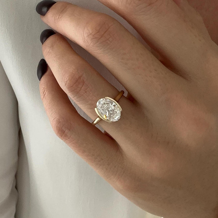 Oval cut moissanite half bezel solitaire engagement ring in yellow gold, view 2