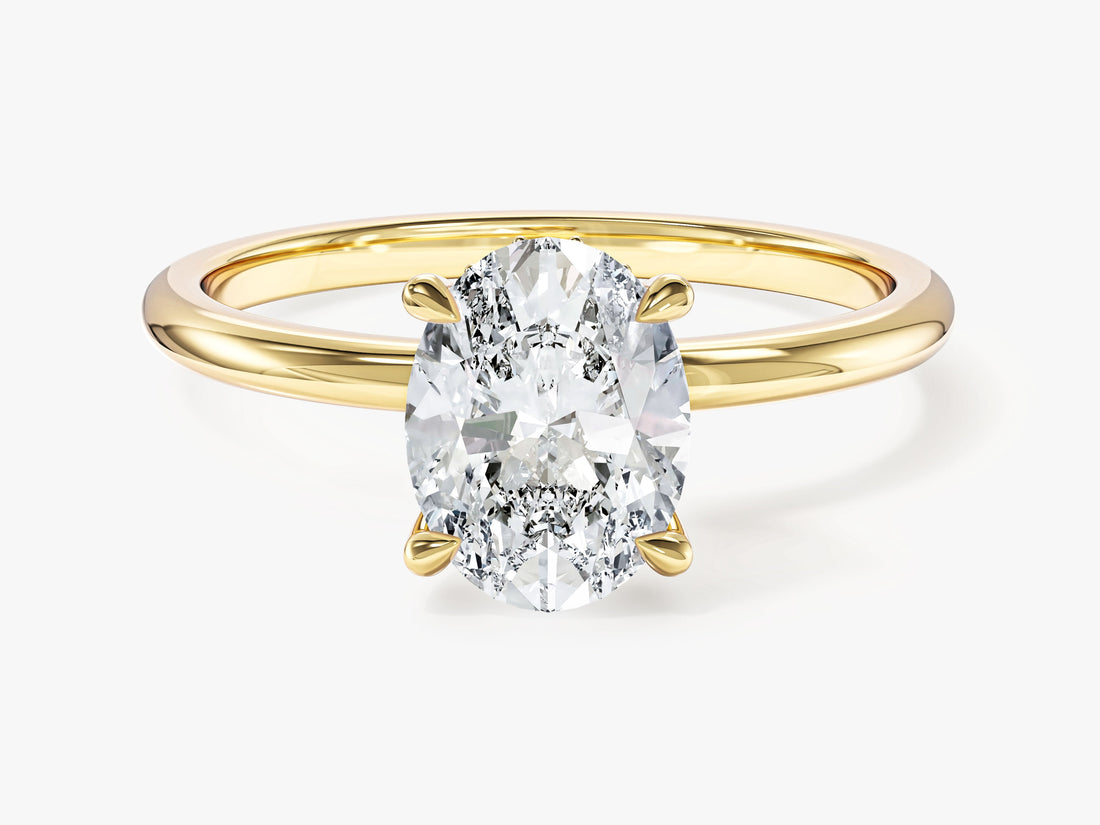 Oval moissanite solitaire engagement ring with hidden halo and four claw setting in yellow gold, front view