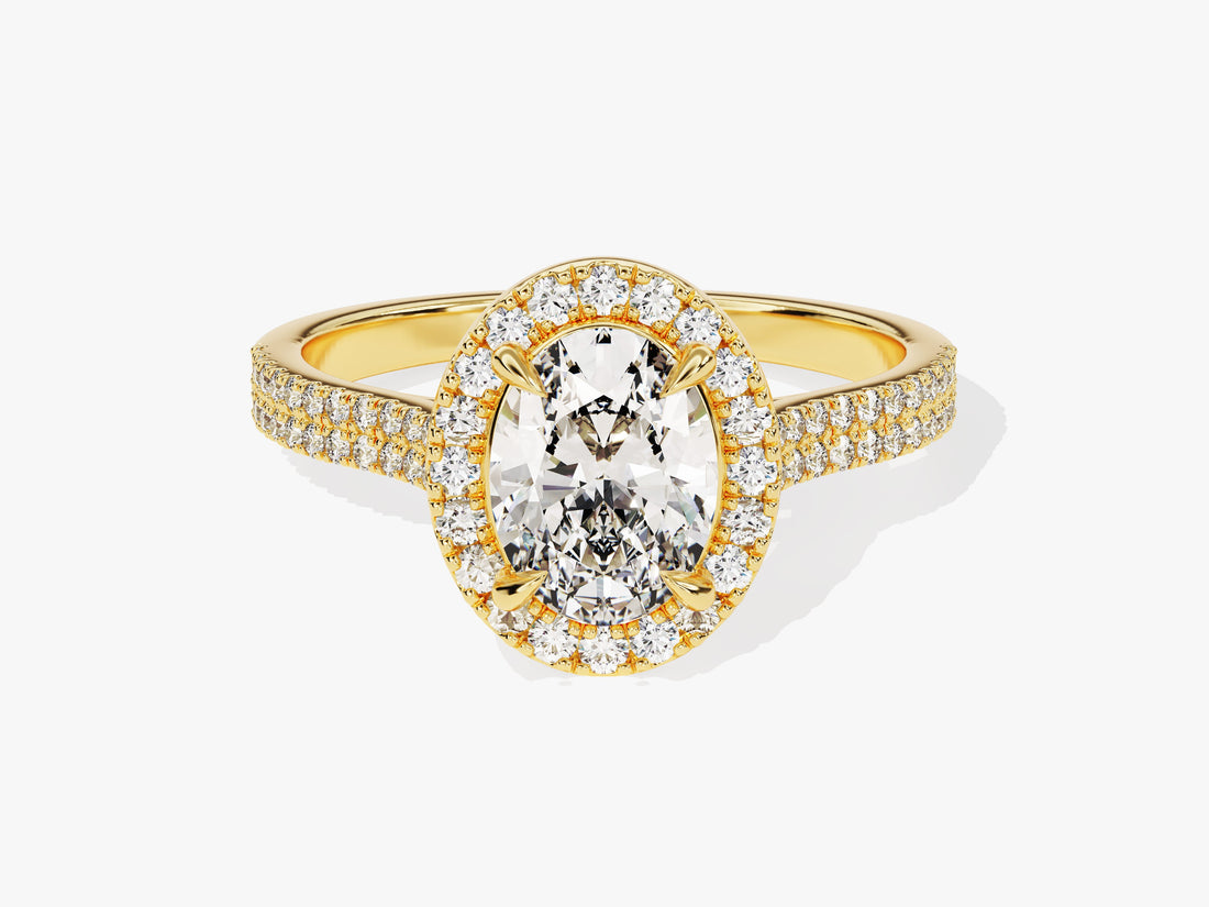 Oval cut moissanite halo engagement ring with two row micro pave shank in yellow gold, front view