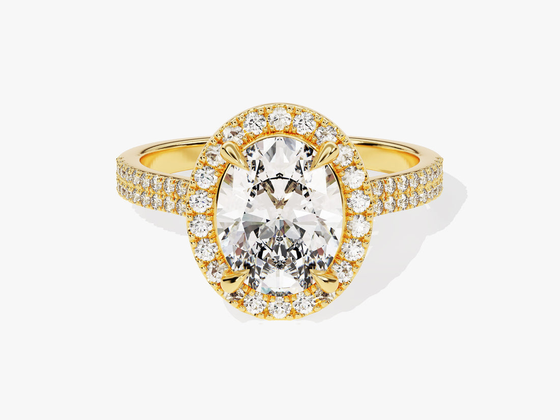 Oval moissanite halo engagement ring with double row pave band in yellow gold, front view