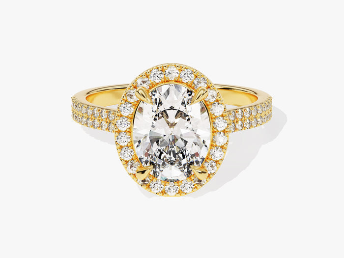 Oval moissanite halo engagement ring with double row pave band in yellow gold, front view