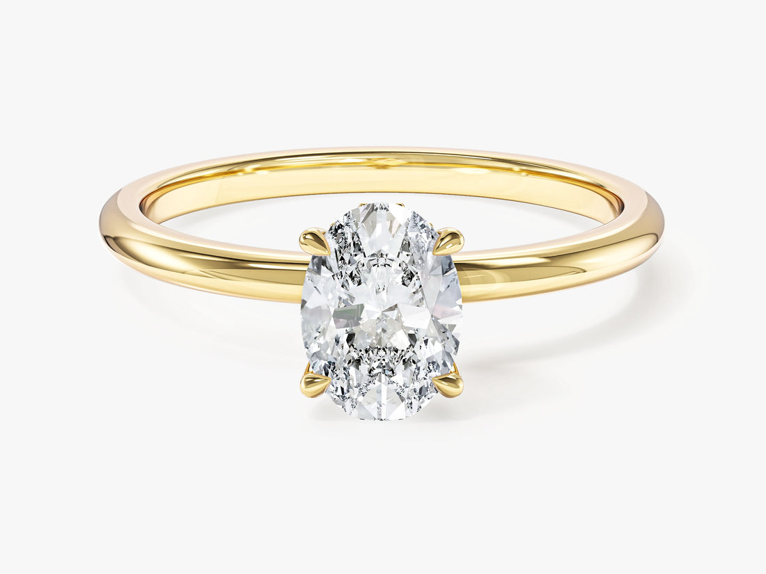 Oval lab grown diamond four prong solitaire with hidden halo in yellow gold, front view