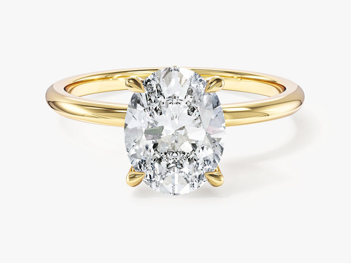 Oval lab grown diamond minimalist secret halo engagement ring in yellow gold, front view