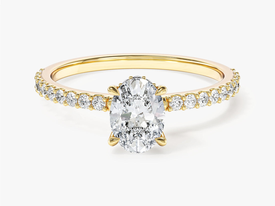 Dainty oval moissanite pave engagement ring with hidden halo in yellow gold, front view