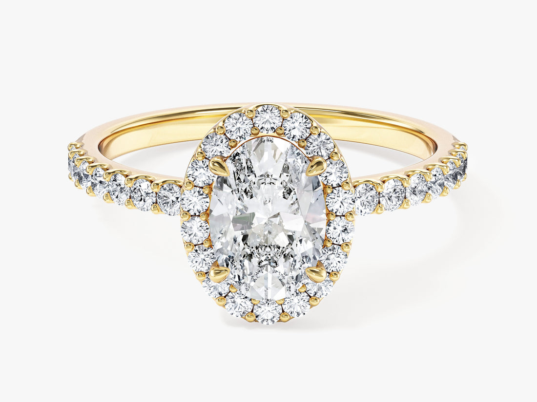 Dainty oval moissanite halo engagement ring with pave shoulders in 14K yellow gold, front view