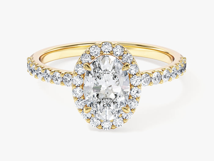 Dainty oval moissanite halo engagement ring with pave shoulders in 14K yellow gold, front view