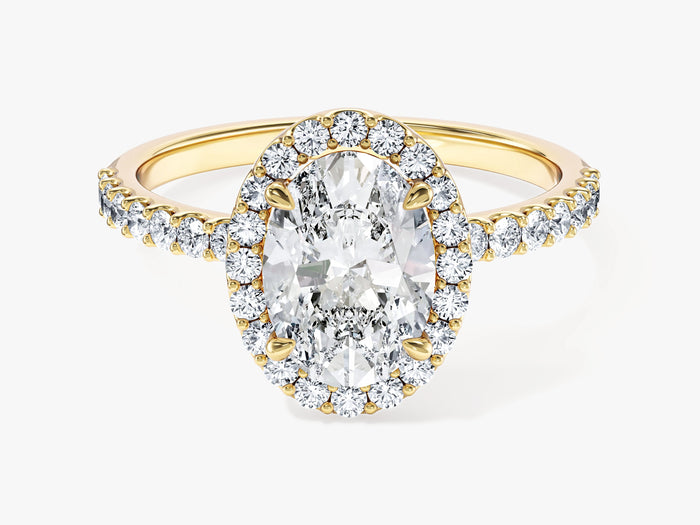 Classic oval moissanite halo engagement ring on a half pave band in 14K yellow gold, front view
