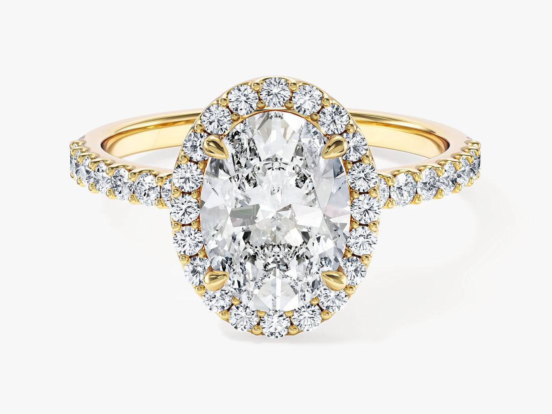 Oval lab grown diamond halo engagement ring with pave band in yellow gold, front view