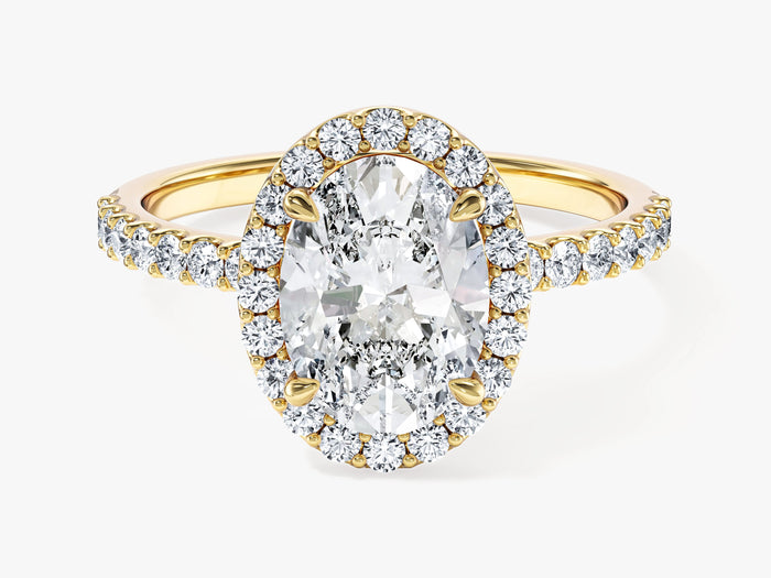 Oval lab grown diamond halo engagement ring with pave band in yellow gold, front view