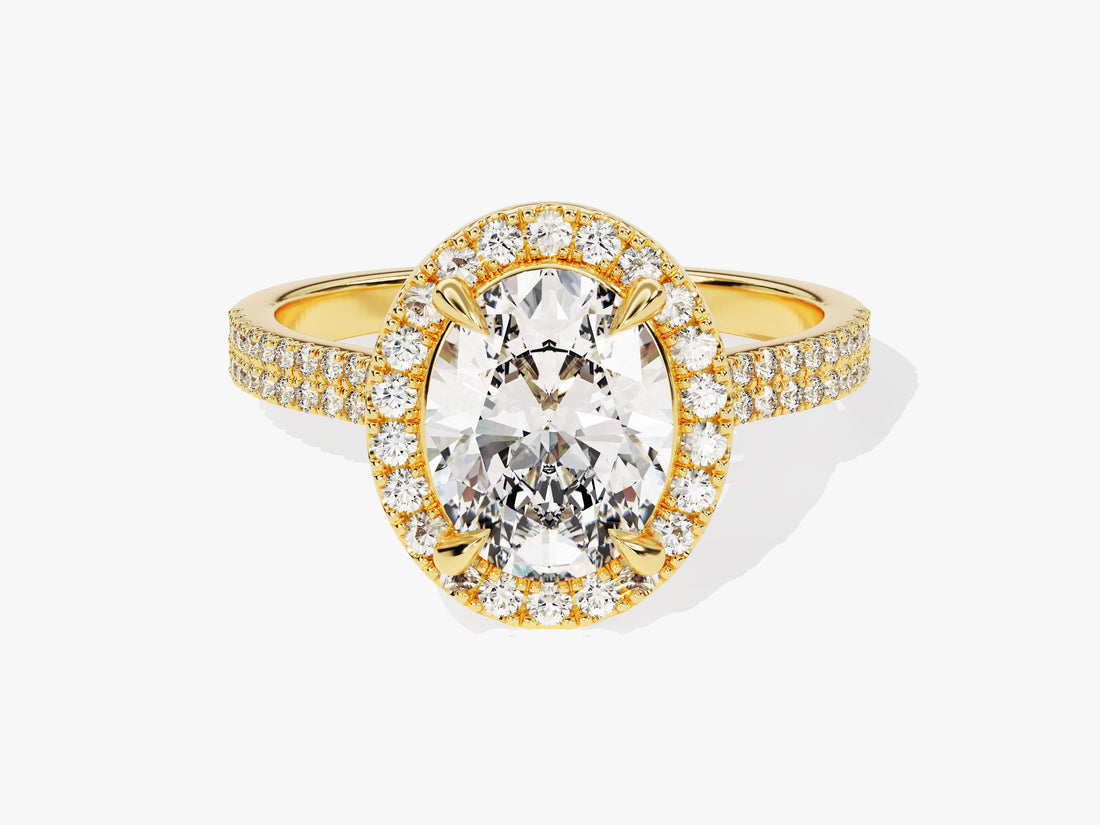 Oval lab grown diamond halo engagement ring with double row pave band in yellow gold, front view
