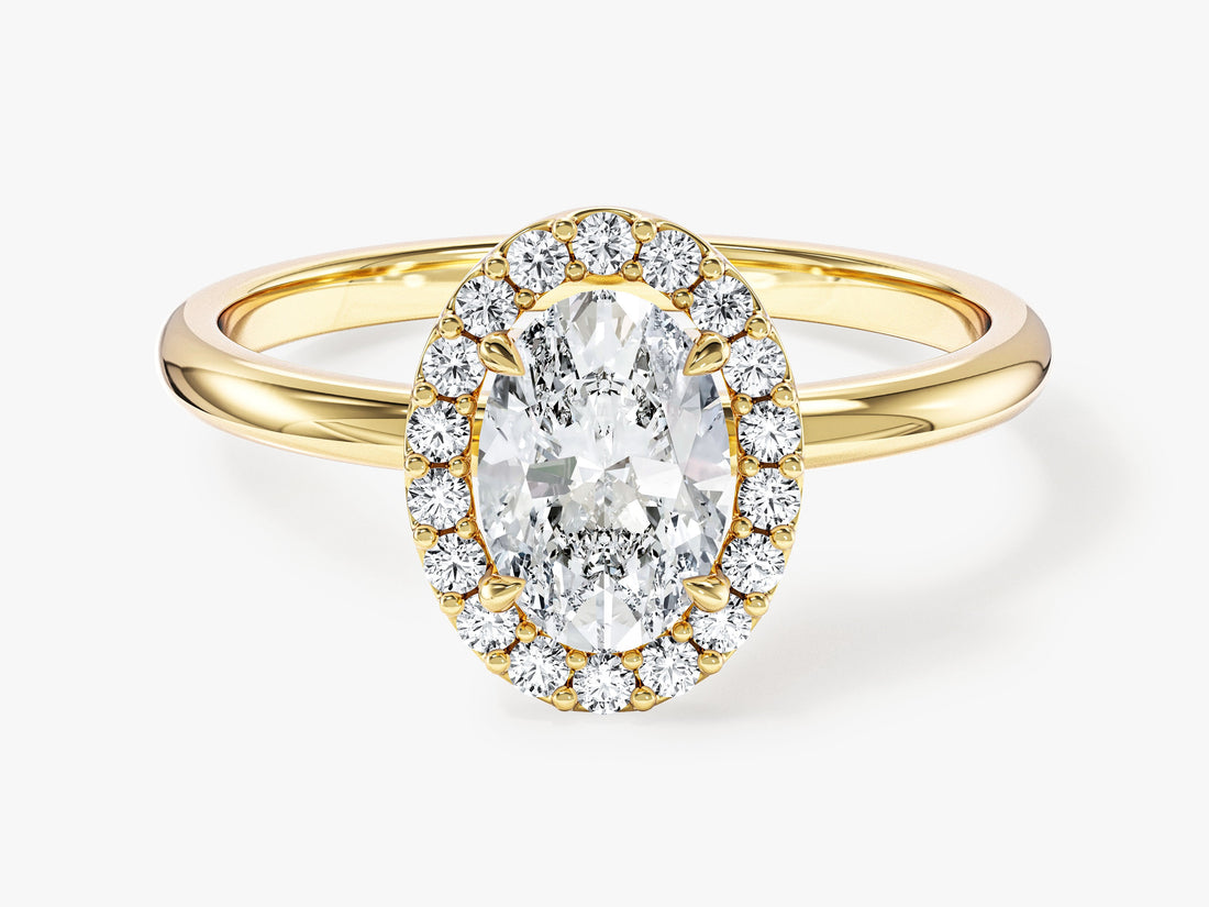 Dainty oval lab grown diamond halo engagement ring in yellow gold, front view