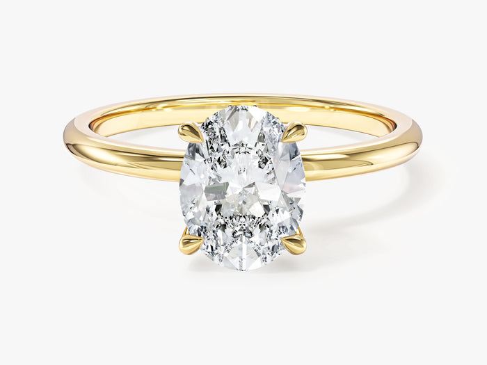 Oval lab grown diamond hidden halo engagement ring in yellow gold, front view on a plain slim band