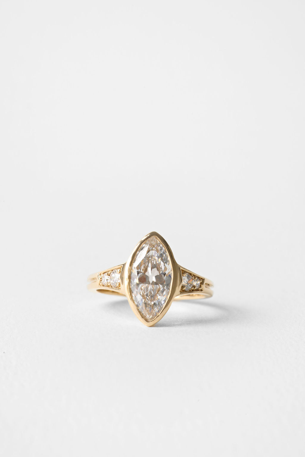 Old mine marquise moissanite bezel engagement ring with pave shoulders in yellow gold