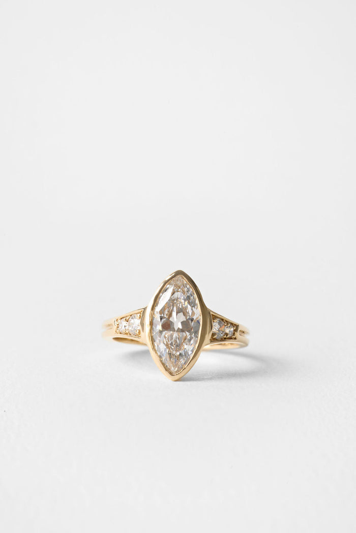 Old mine marquise moissanite bezel engagement ring with pave shoulders in yellow gold
