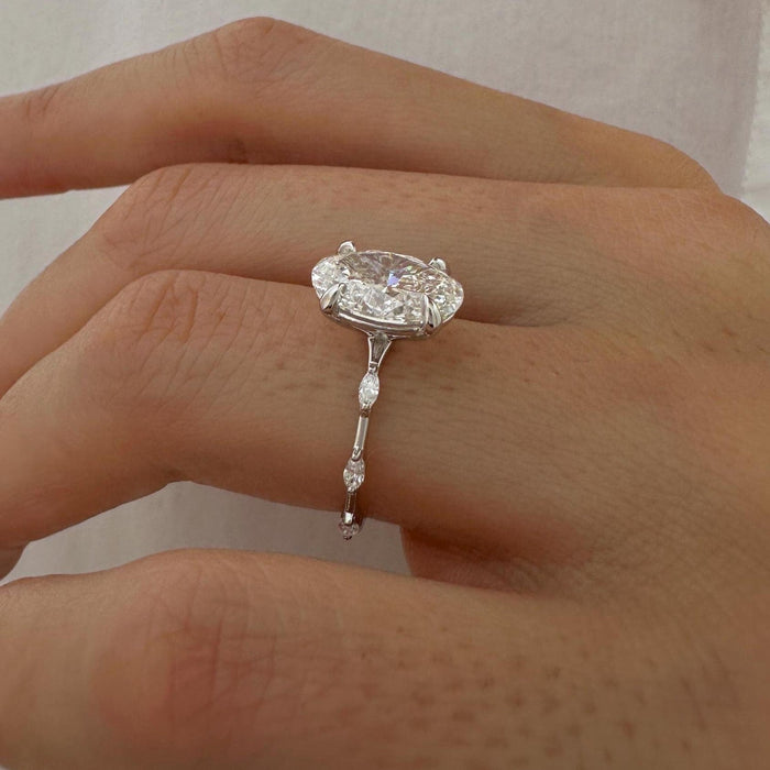 Oval cut moissanite engagement ring with marquise station band in white gold, view 2