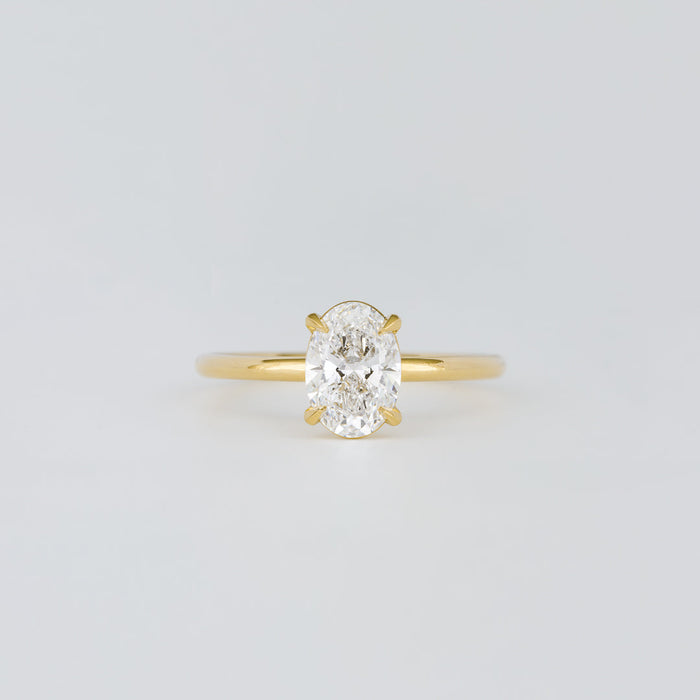 Oval cut moissanite petite four claw solitaire engagement ring in yellow gold