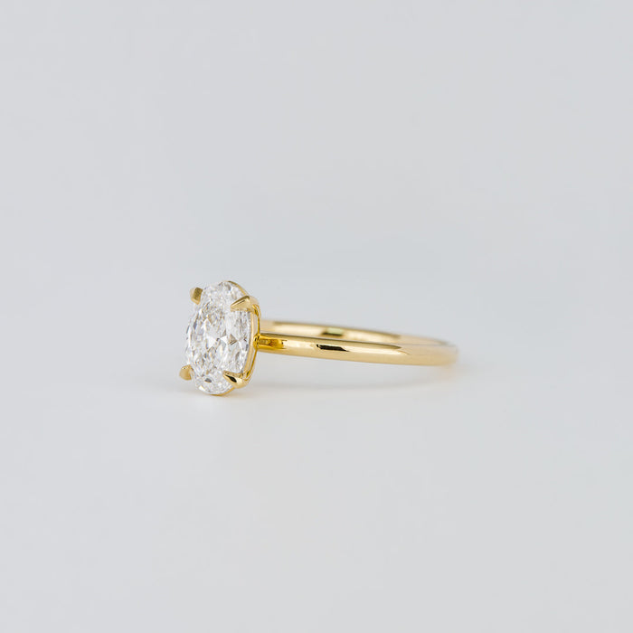 Oval cut moissanite petite four claw solitaire engagement ring in yellow gold, view 2