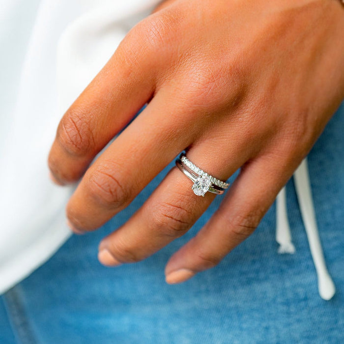 Oval cut moissanite petite solitaire engagement ring on a flat edge rose gold band, view 2