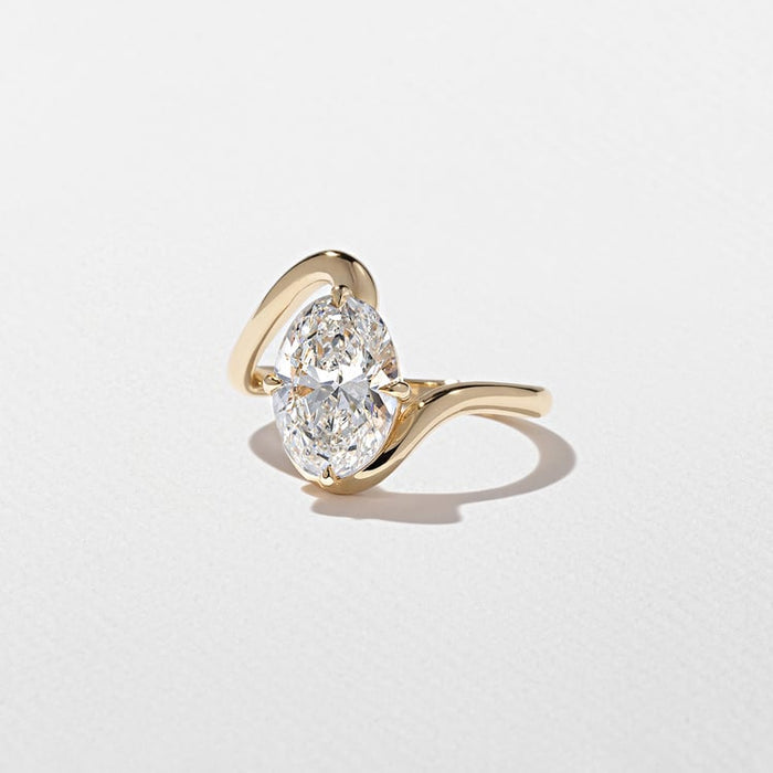 Oval cut moissanite sculptural swirl solitaire engagement ring in yellow gold, view 2