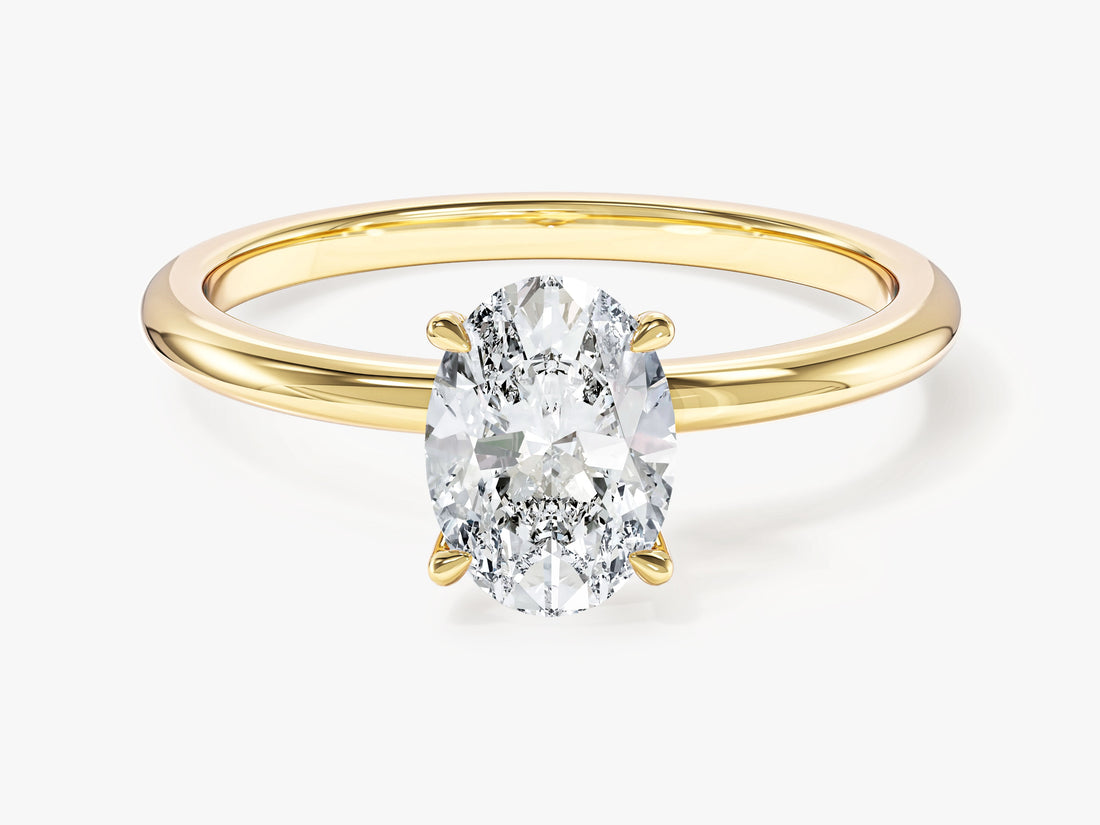 Dainty oval lab grown diamond solitaire engagement ring in yellow gold, front view