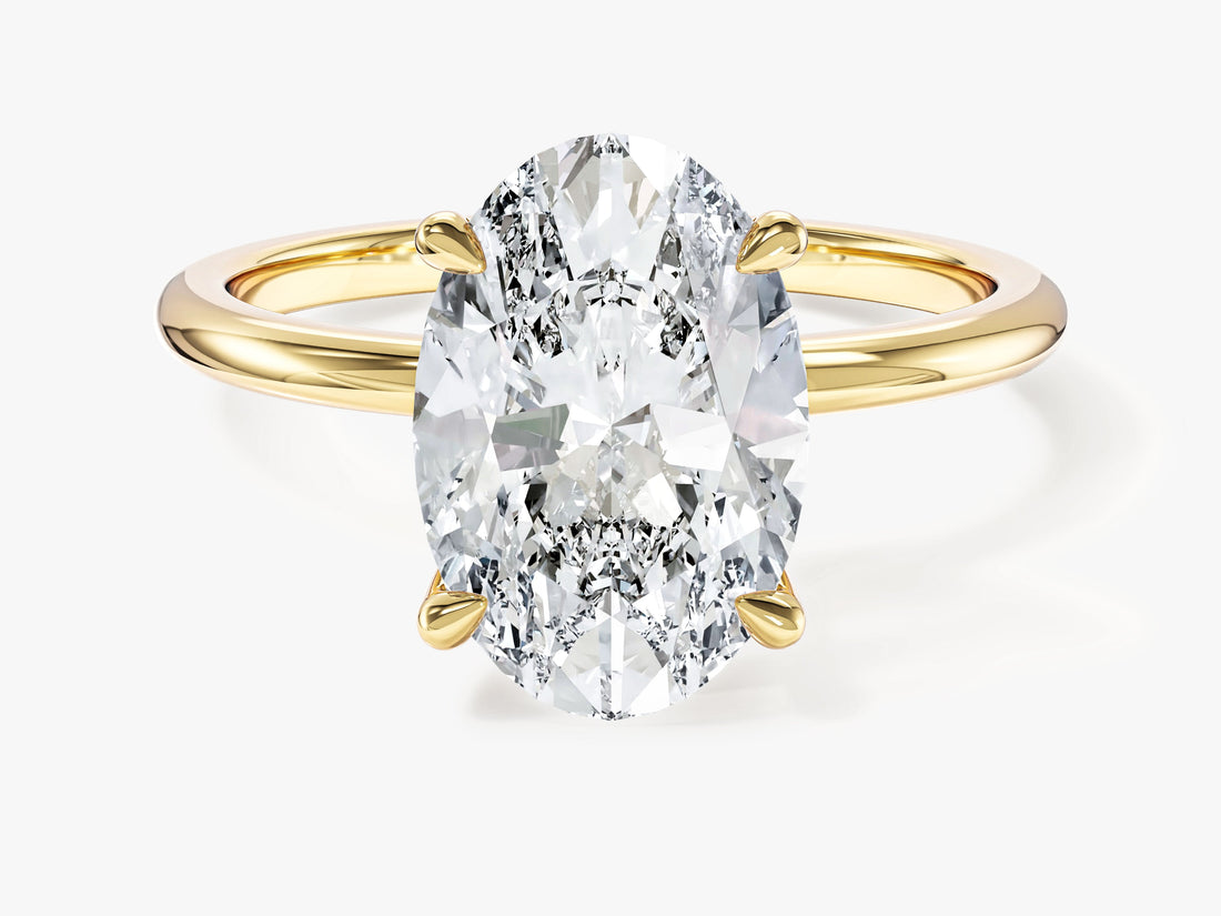 Elongated oval lab grown diamond solitaire engagement ring in yellow gold, front view