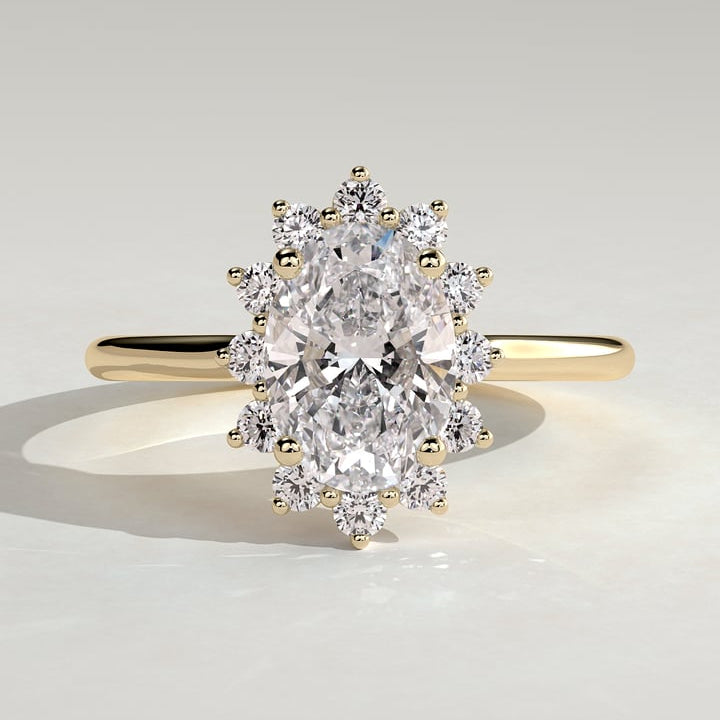 Oval cut moissanite sunburst claw set halo engagement ring in yellow gold