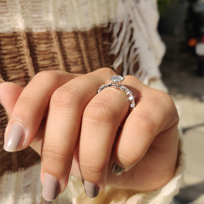 Oval cut moissanite engagement ring with spaced marquise accents on a hairline white gold band, view 2