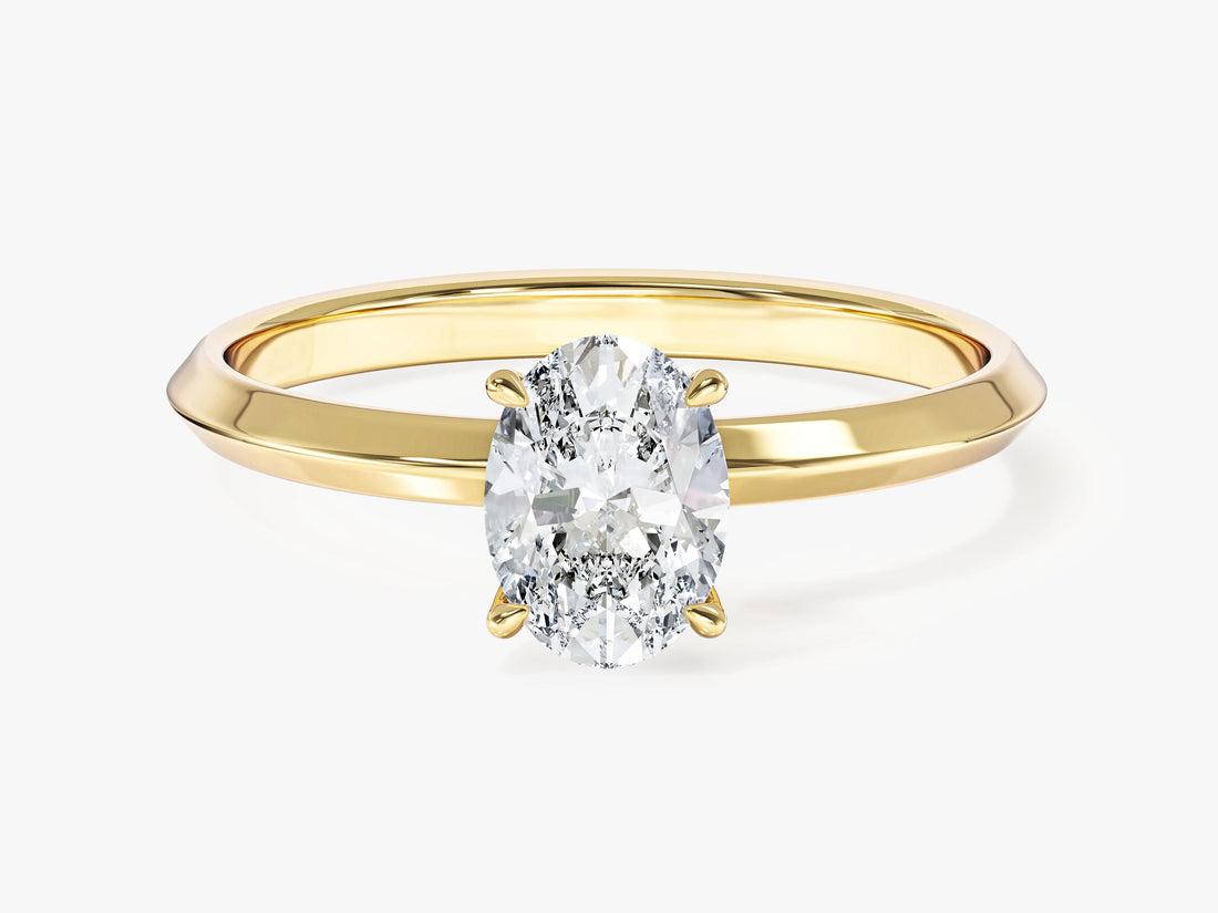 Oval moissanite knife edge solitaire engagement ring in 14K yellow gold, front view