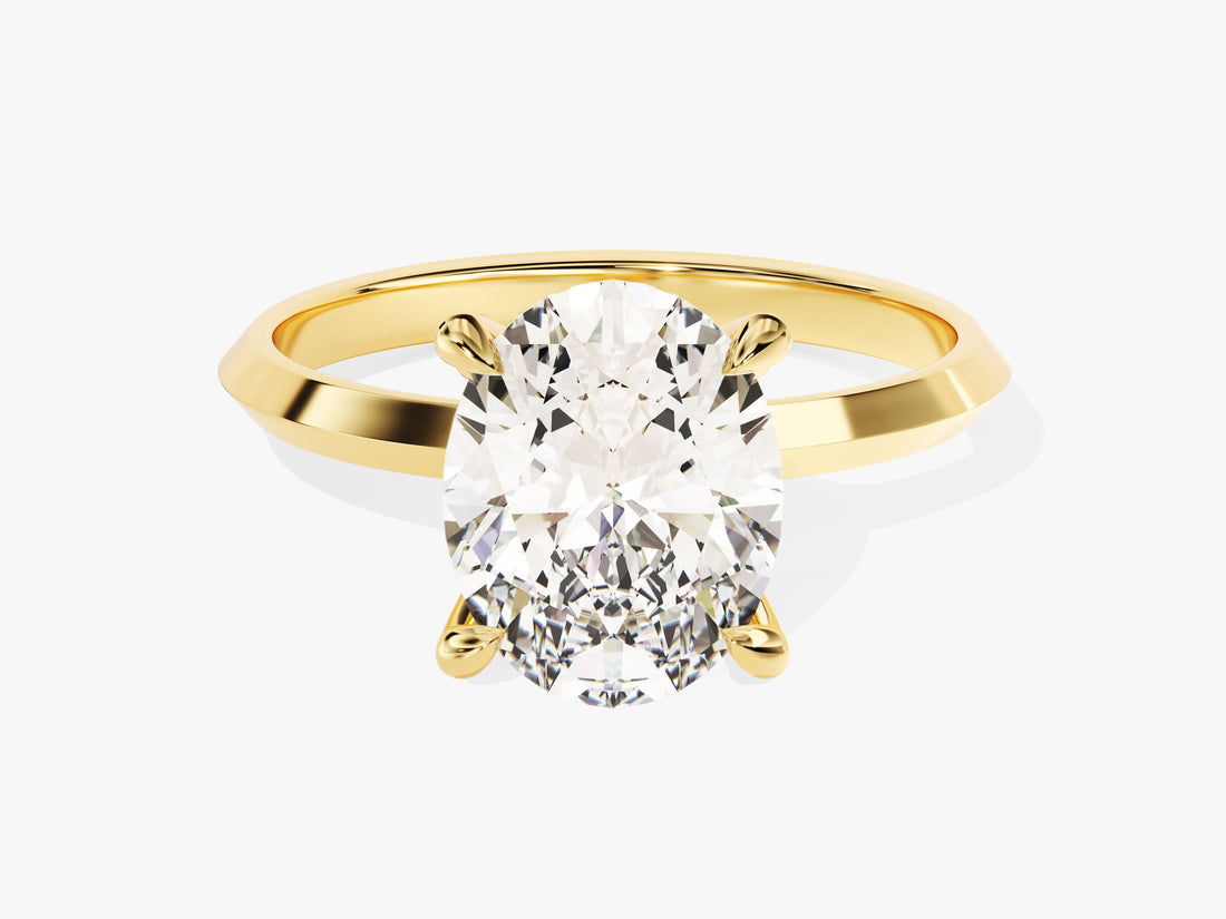 Bold oval moissanite statement solitaire with knife edge shank in 14K yellow gold, front view