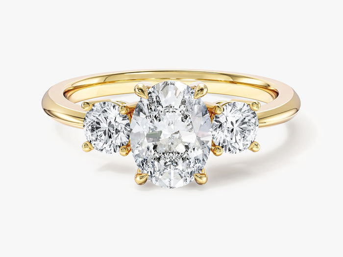 Oval lab grown diamond three stone engagement ring with round side stones in yellow gold, front view