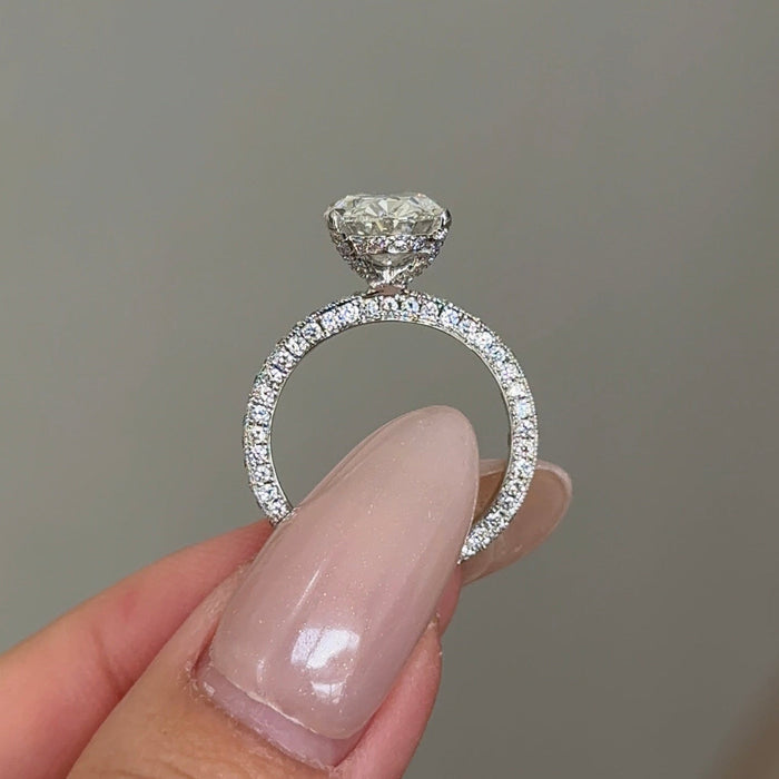 Oval cut moissanite hidden halo engagement ring with three sided pave shank in white gold, view 2