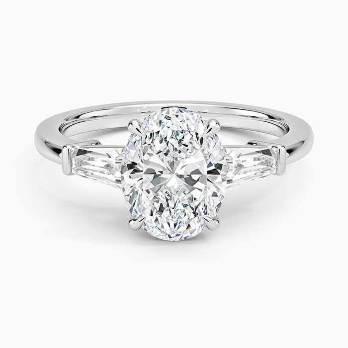 Oval moissanite tapered baguette three stone ring in white gold, top view