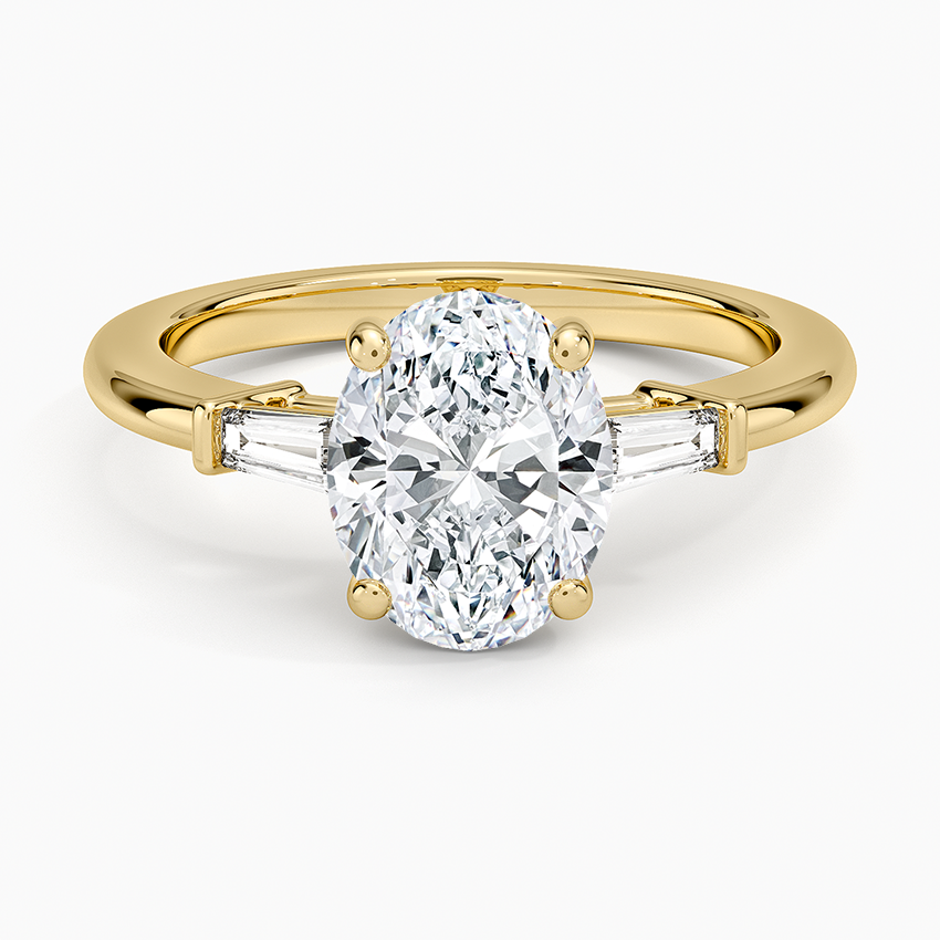 Oval moissanite with bar set tapered baguettes on a plain yellow gold band, top view