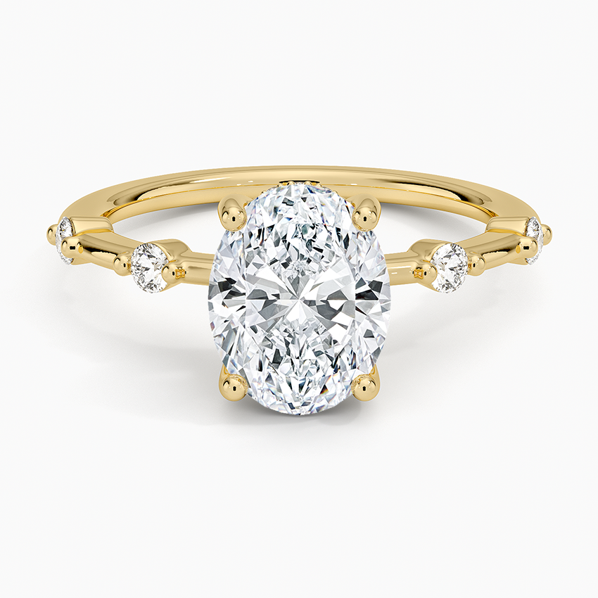 Oval moissanite with beaded accent stations in yellow gold, top view