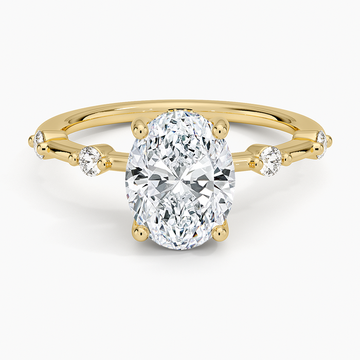 Oval moissanite with beaded accent stations in yellow gold, top view