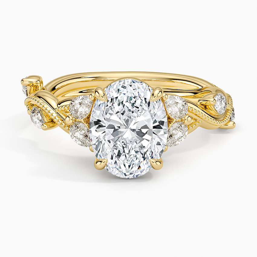Oval moissanite with paired accents and bezel set milgrain vine in yellow gold