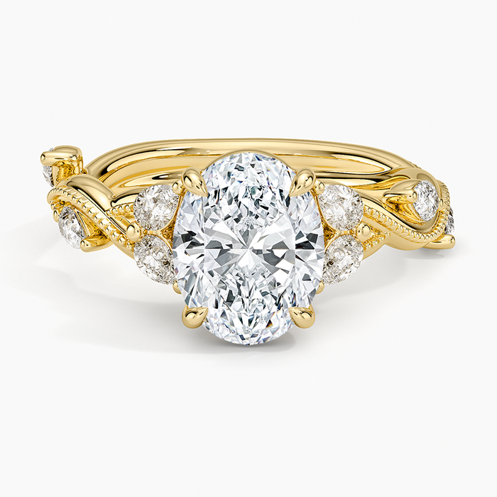 Oval moissanite with paired accents and bezel set milgrain vine in yellow gold