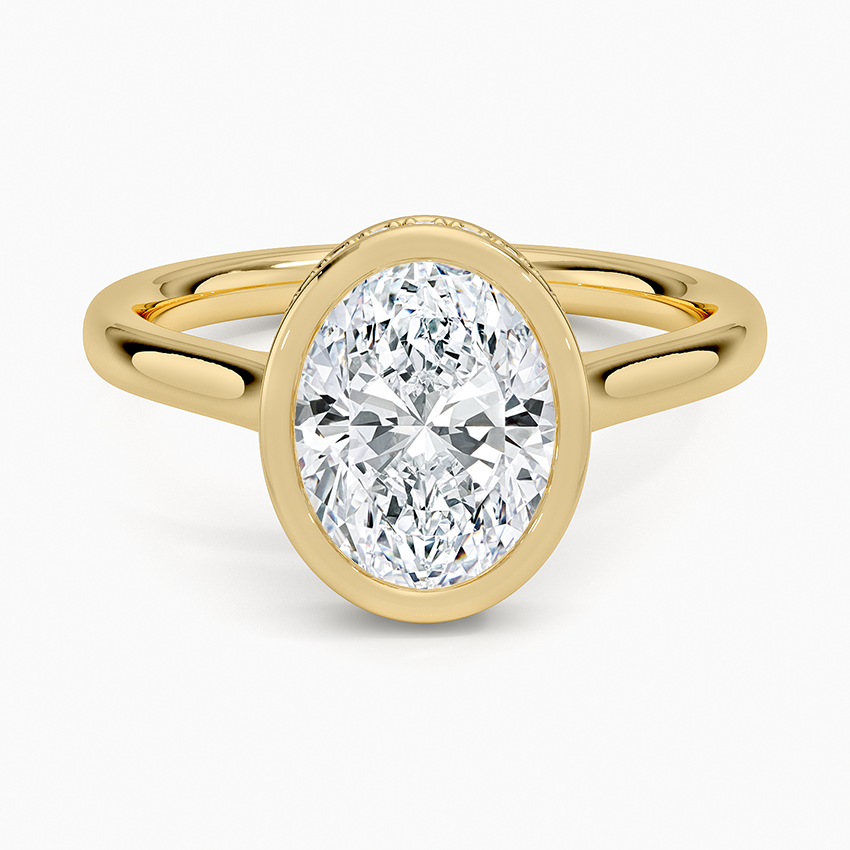 Full bezel oval moissanite on a split shank yellow gold band, top view