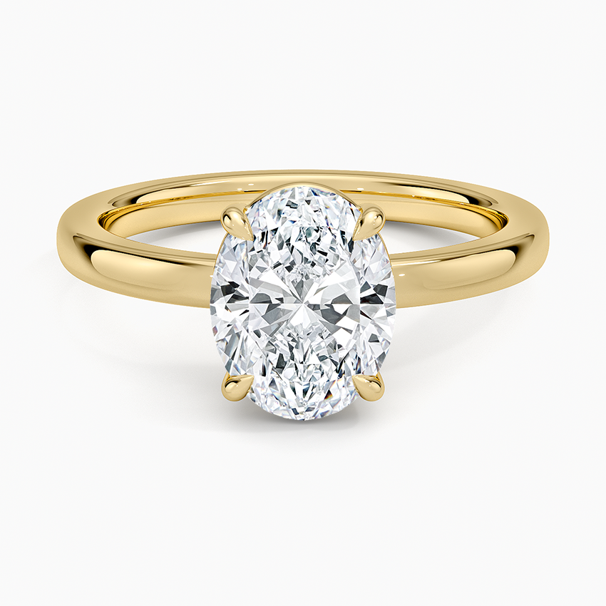 Oval moissanite solitaire on a tapered yellow gold band, top view
