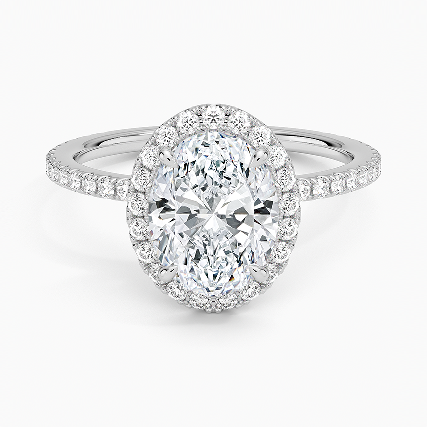 Oval moissanite with a full pave halo and pave band in white gold, top view