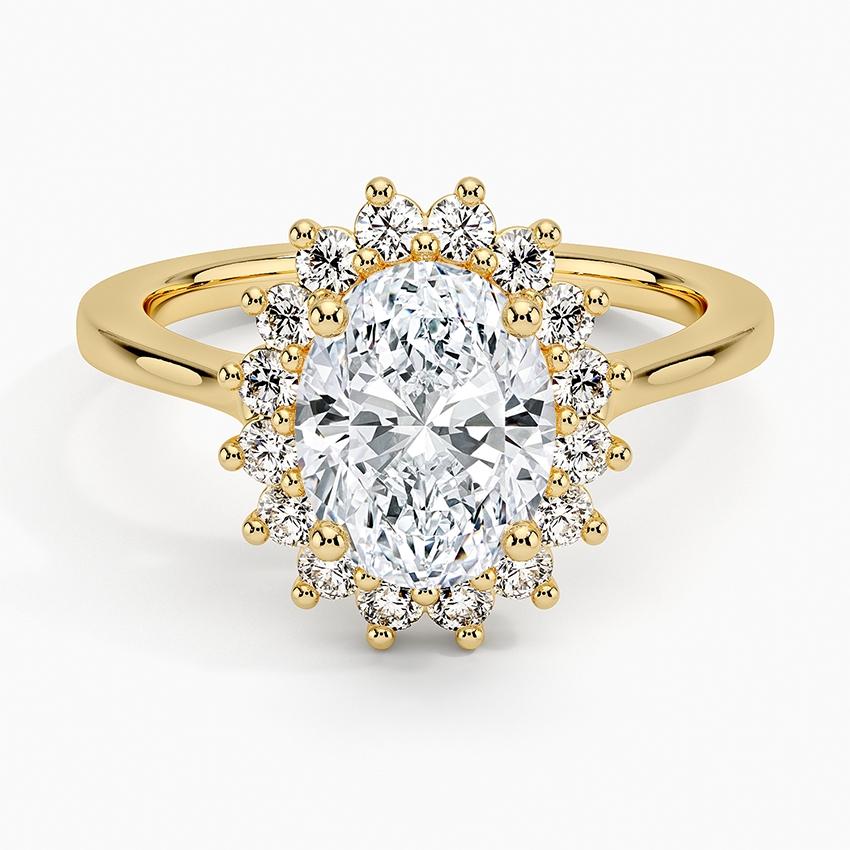 Oval moissanite with a claw set round halo on a plain yellow gold band, top view