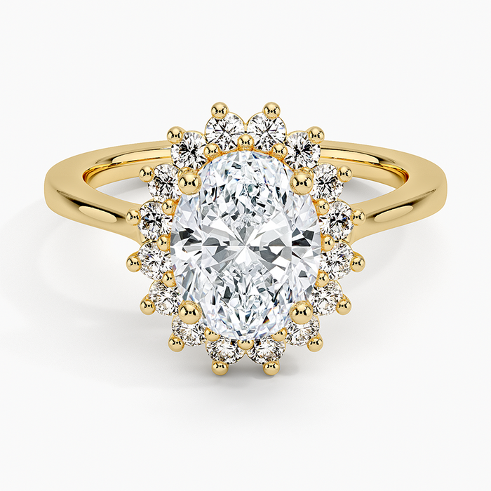 Oval moissanite with a claw set round halo on a plain yellow gold band, top view
