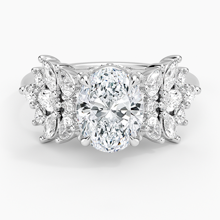 Oval moissanite with marquise and pear cluster wings in white gold, top view