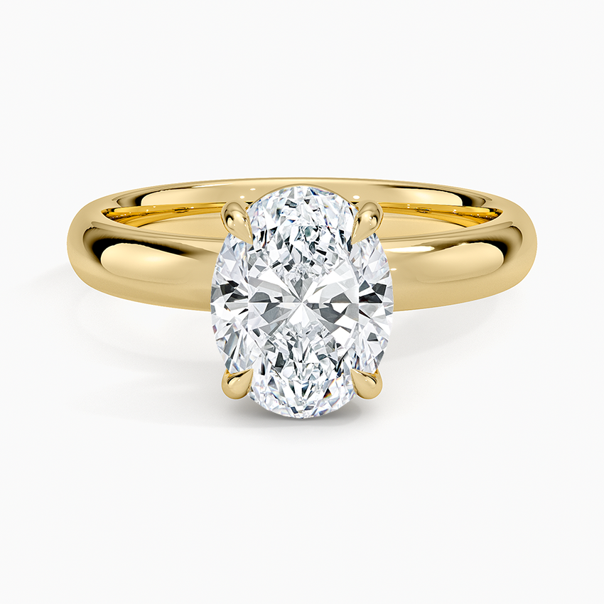 Oval moissanite solitaire on a 3 mm comfort fit yellow gold band, top view