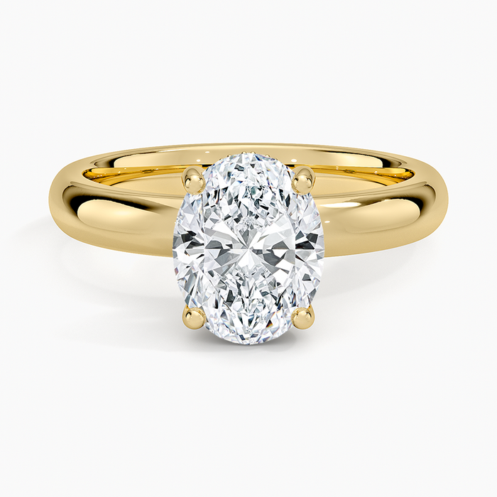Oval moissanite on a wide domed yellow gold band, top view