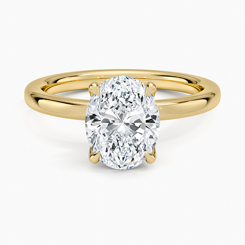 Oval moissanite solitaire on a heavy domed yellow gold band, top view