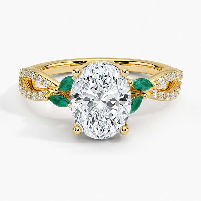 Oval moissanite with green marquise emerald leaves in yellow gold, top view